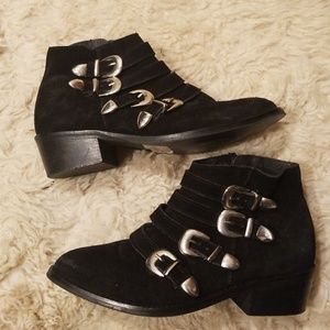 Black suede booties with silver buckles